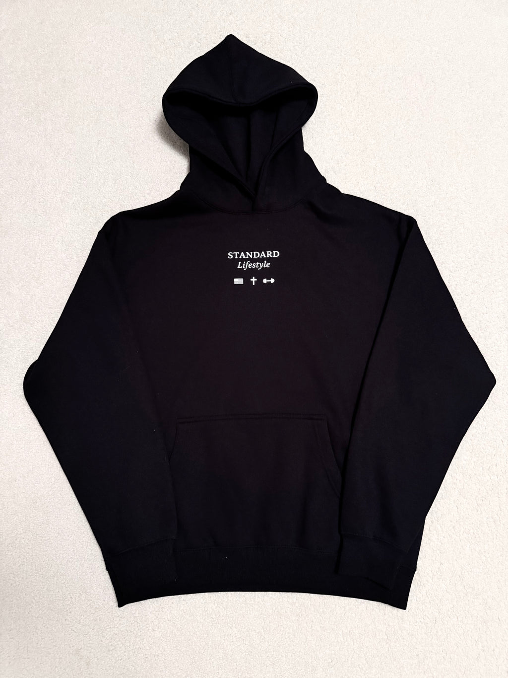 Black pullover front flat lay with small chest logo